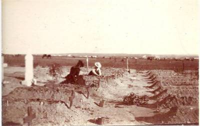 Two women tending to fresh graves at Kroonstadt.