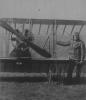 Andrew Delfosse BADGERY standing next to his French Caudron biplane  